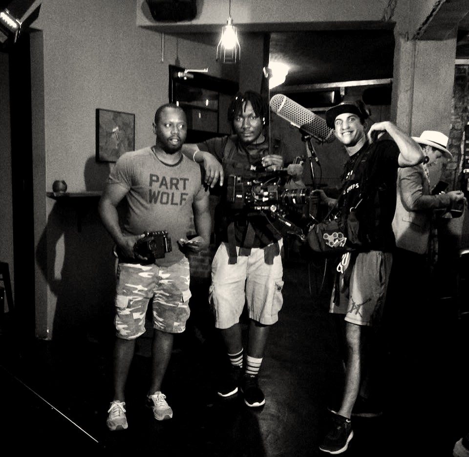 Three crew members with a cinema camera and boom microphone