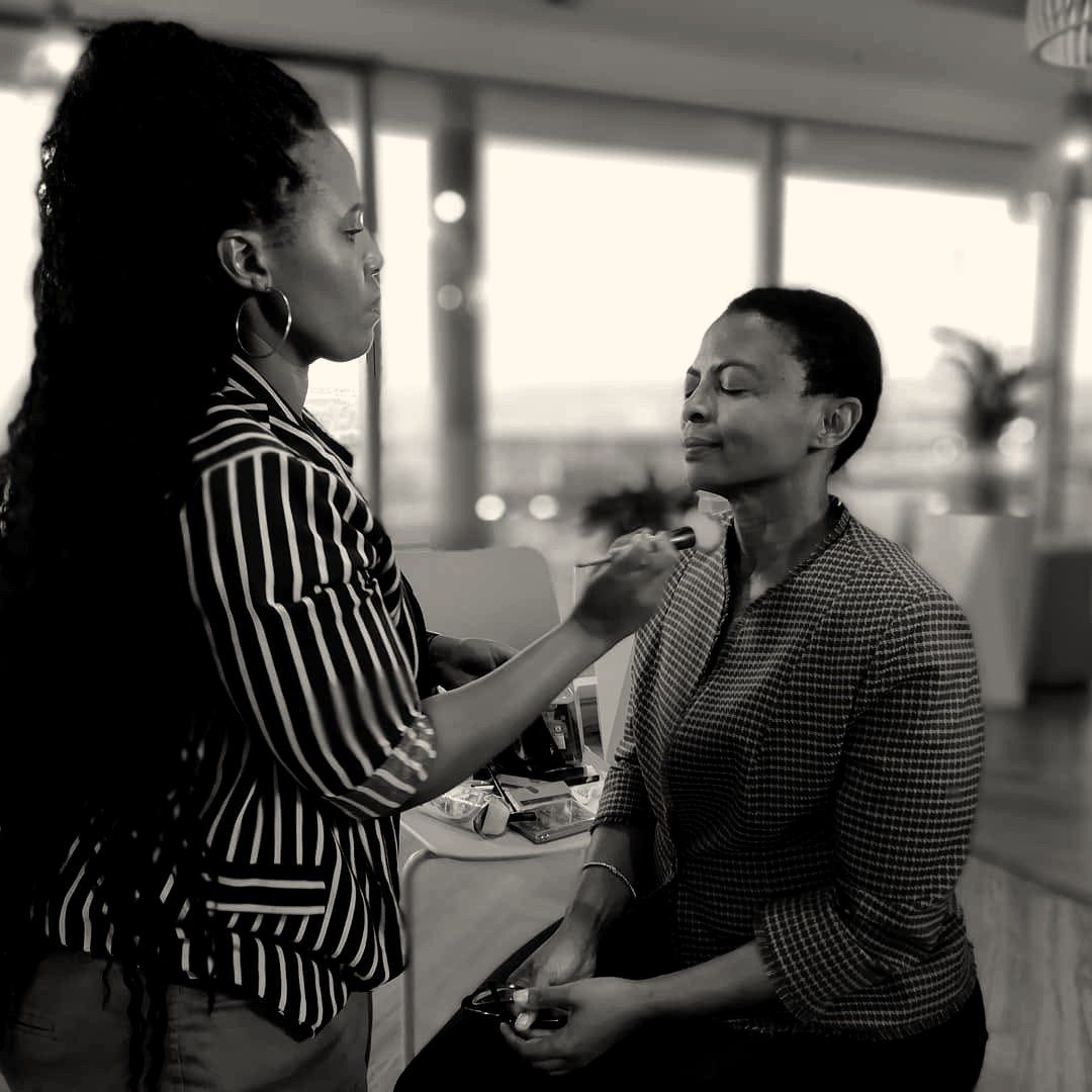 A make-up artist preparing an interview guest before filming