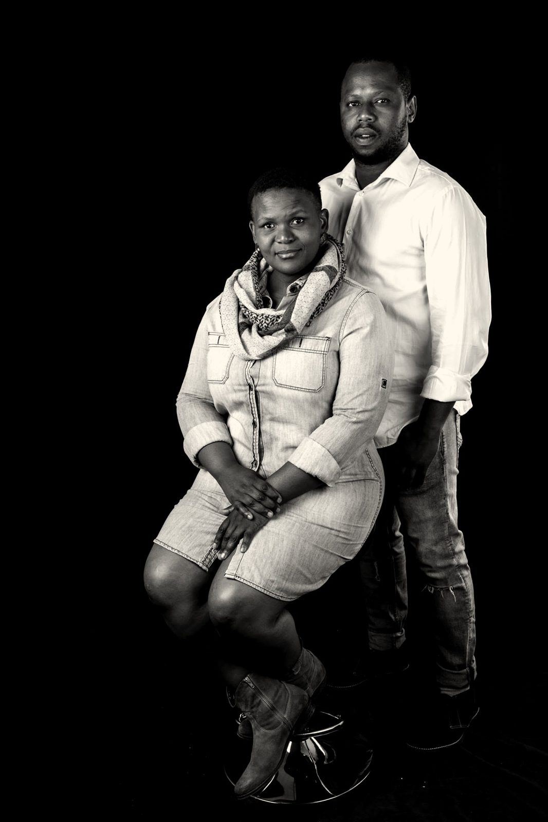 Studio portrait of Sam and Lucia Tengani against a black backdrop