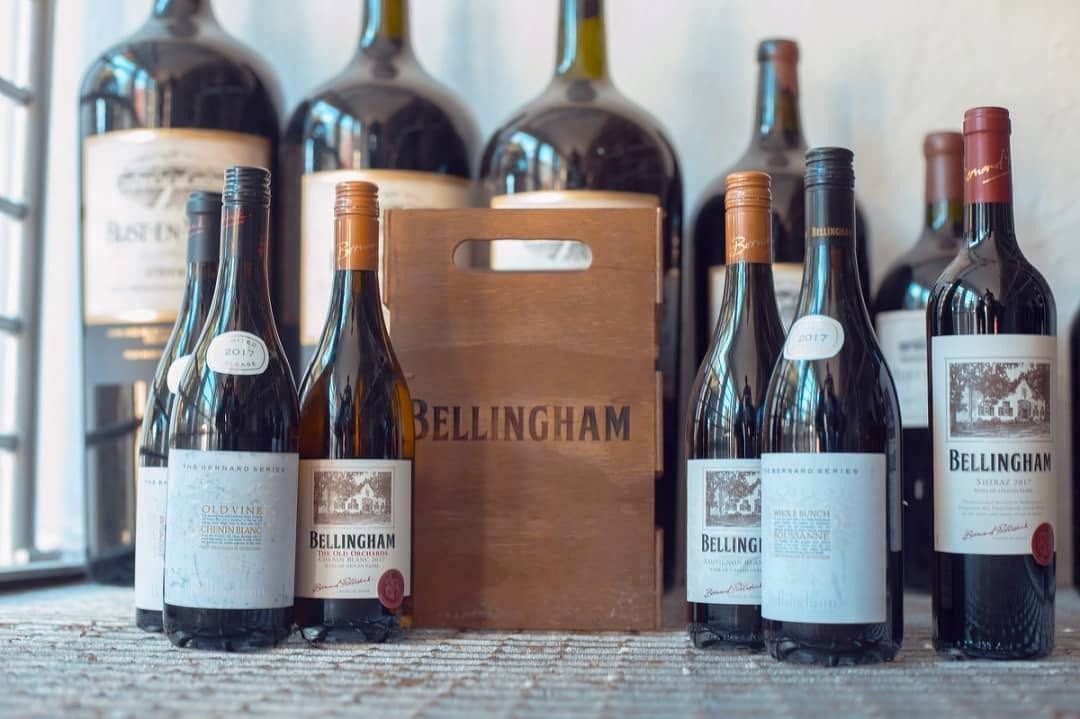 Bellingham wine bottles arranged around a wooden carrier